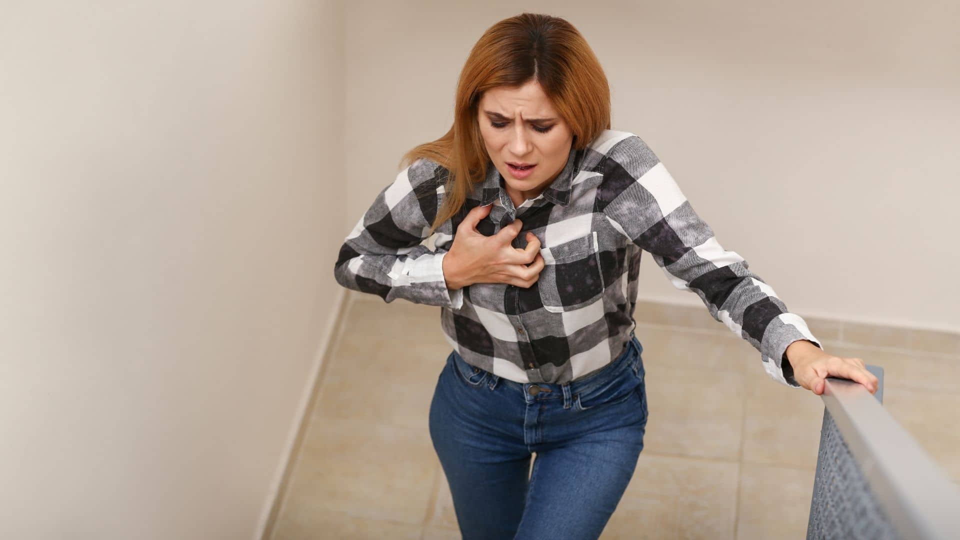 woman holding chest from panic attack