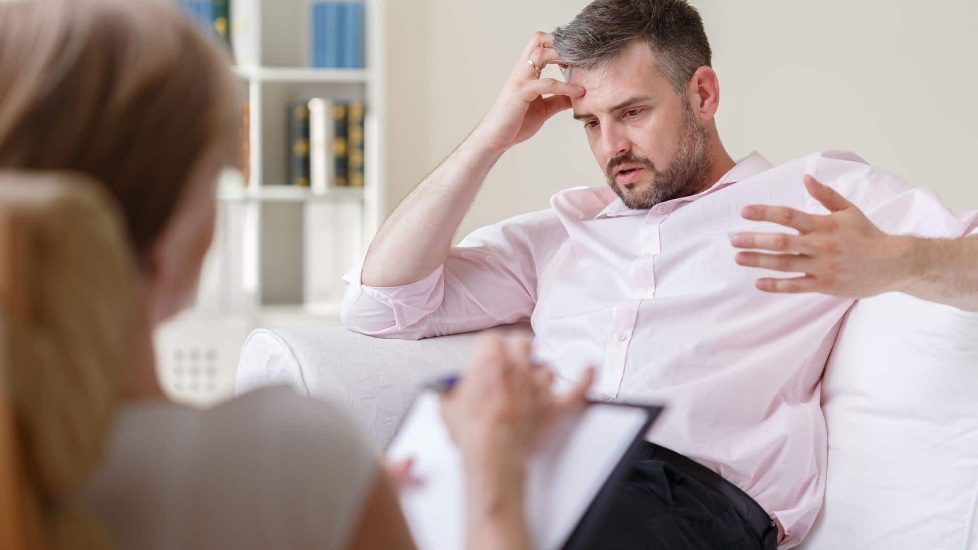 stressed man talking to therapist