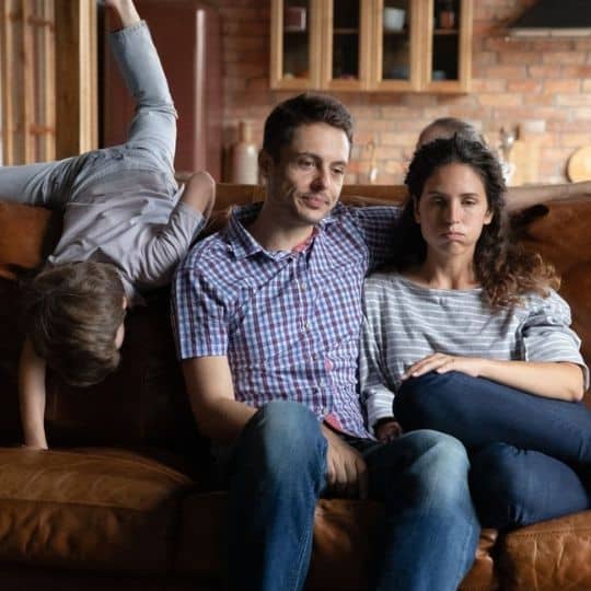Stressed couple with child playing